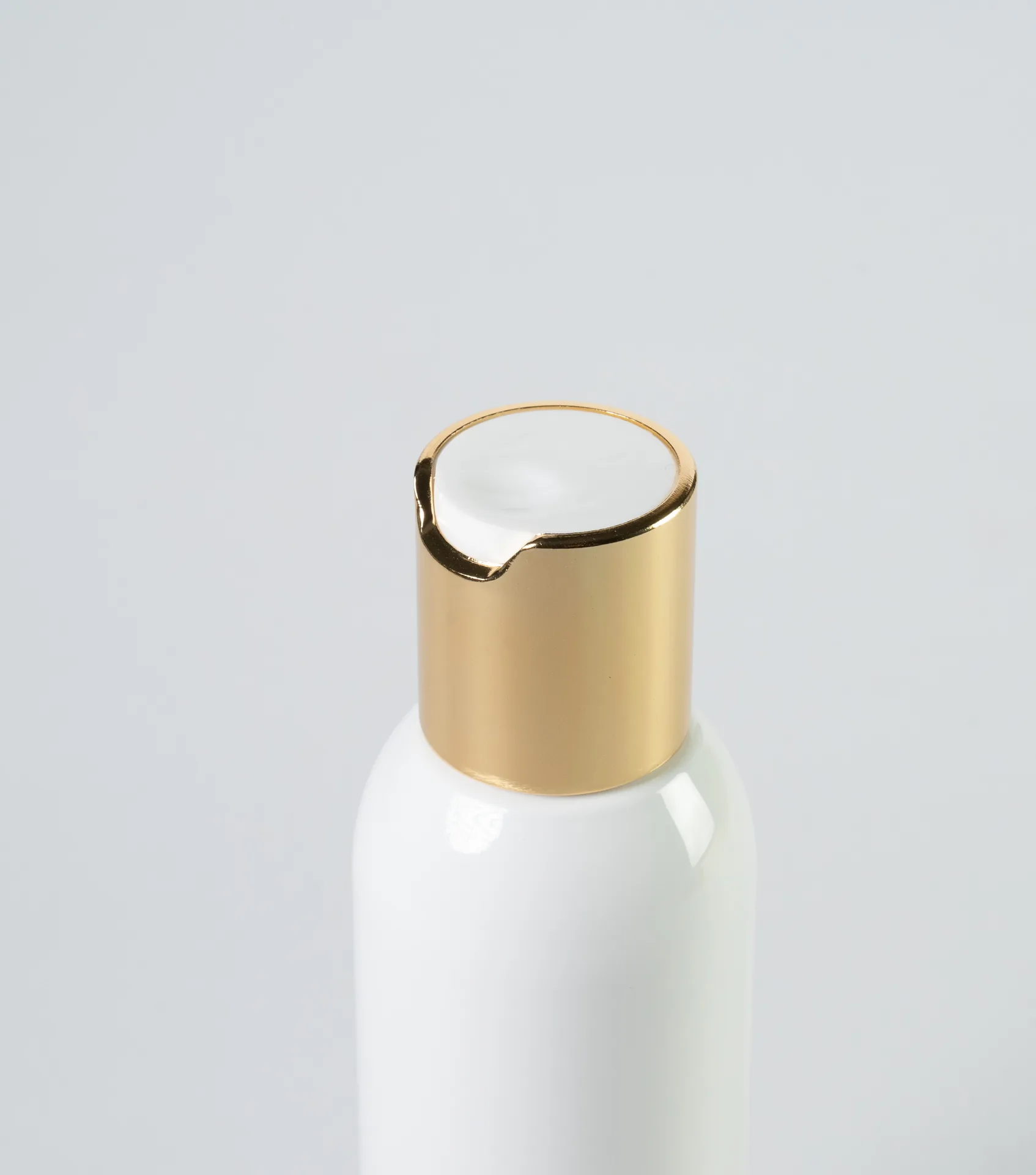 Flacone bianco con tappo disc-top dorato